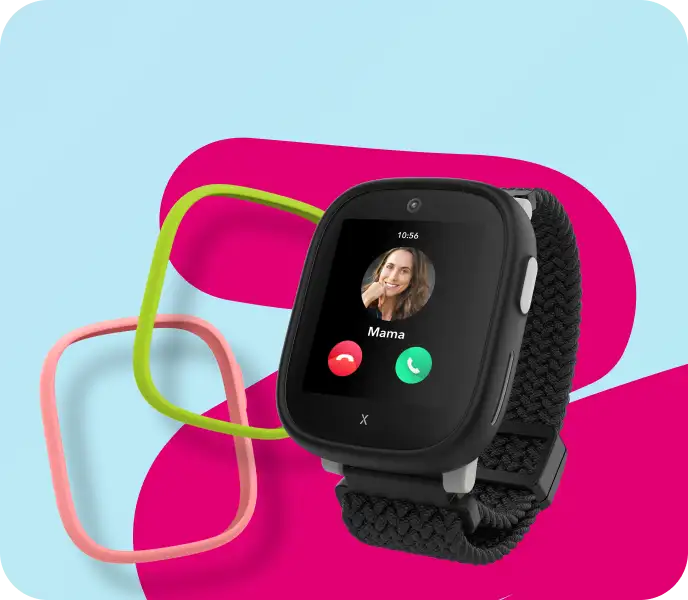 Schwarze XPLORA X6 Kinderuhr mit grünem und pinken Uhrenrahmen vor grauem und magentafarbenem Hintergrund.